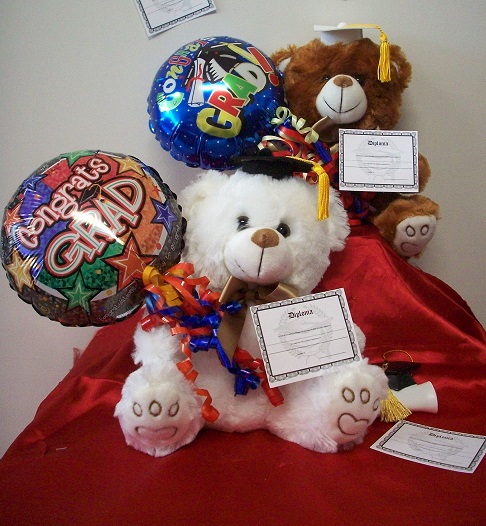 Graduation bear holding balloon
